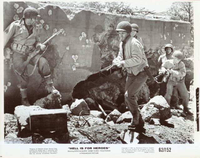 This seems to be from a deleted scene or perhaps is just staged for the photographer.
Sgt. Pike (Fess Parker) and Reese (McQueen) in the foreground as the squad advance...